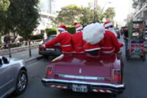 Free download Men dressed as a Santa Claus parade on a old car on the last day of 2017 in Gaza city, Palestine, Dec. 31, 2017.Photos by Mohammed Zaanoun free photo or picture to be edited with GIMP online image editor