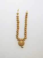 Free download Necklace with bulla and gold beads free photo or picture to be edited with GIMP online image editor