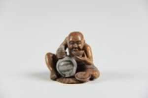 Free download Netsuke of a Man Holding a Small Bottle in One Hand and Drinking from a Cup free photo or picture to be edited with GIMP online image editor