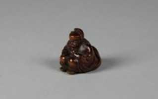 Free download Netsuke of Seated Figure of an Old Man with Backpack Containing a Mask free photo or picture to be edited with GIMP online image editor