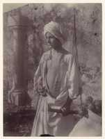 Free download [Young Man in White Robe and Head Gear Holding Scabbard, Sicily, Italy] free photo or picture to be edited with GIMP online image editor