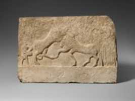 Free download Limestone votive relief with a lion killing a bull and two human figures free photo or picture to be edited with GIMP online image editor