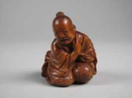 Free download Netsuke of Man Applying Salve free photo or picture to be edited with GIMP online image editor