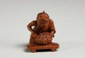 Free download Netsuke of Man Cutting Pumpkin free photo or picture to be edited with GIMP online image editor