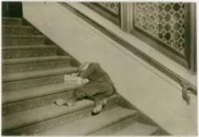 Free download Newsboy asleep on stairs with papers, Jersey City, New Jersey free photo or picture to be edited with GIMP online image editor