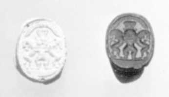 Free download Scarab seal with Bes dominating two lions below a winged sun disc free photo or picture to be edited with GIMP online image editor